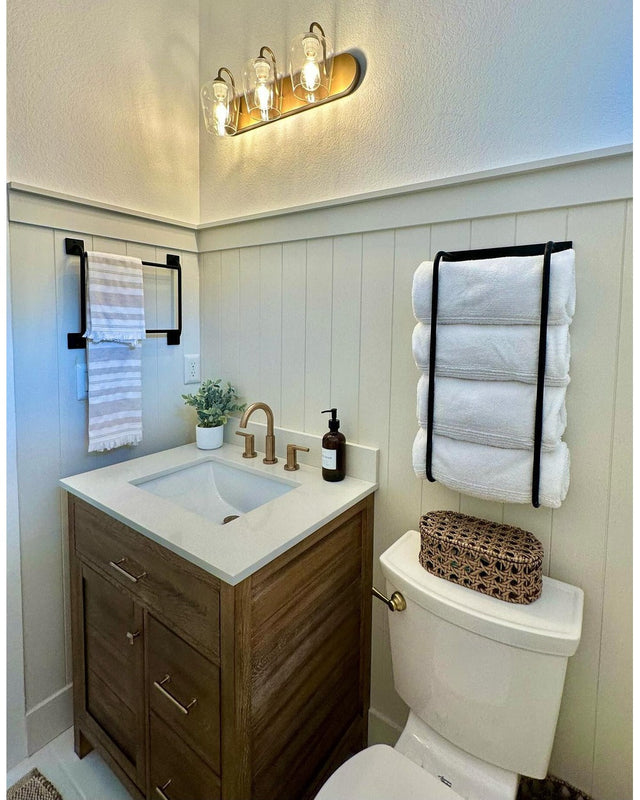 Here's your alt text for that image:      Matte black steel wall mount hooks styled with hanging towels in a clean farmhouse bathroom — Industrial Farm Co
