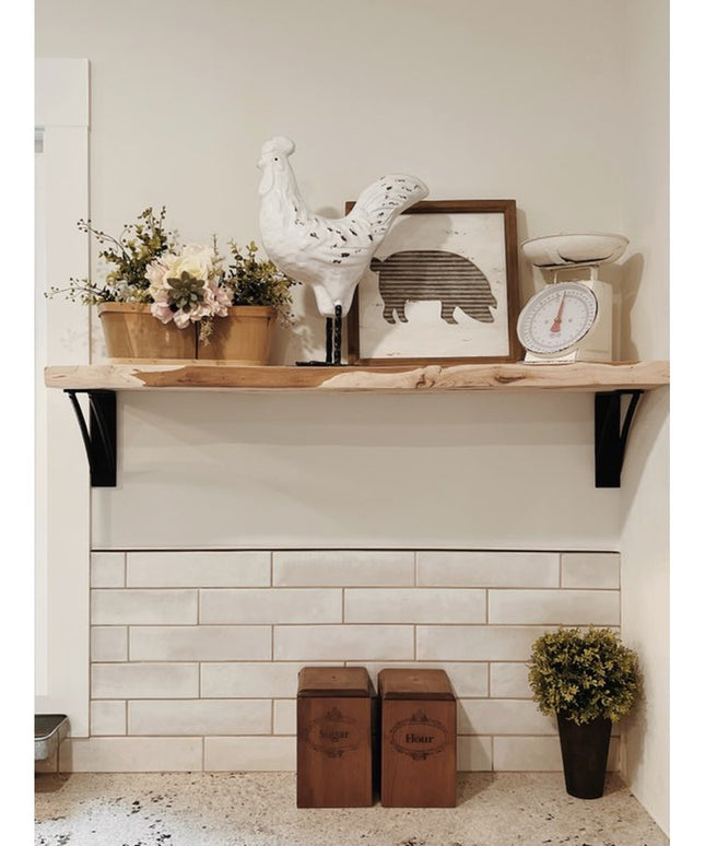 Black metal Niagara Bracket Support from Industrial Farm Co holding rustic wood shelf with farmhouse decor in kitchen setting