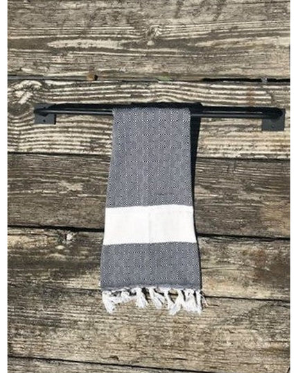 Industrial Farm Co Split Rock black metal towel rack mounted on weathered wood wall with gray and white striped towel