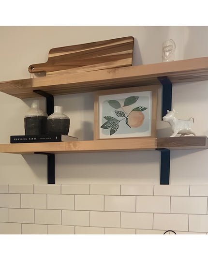 Heavy duty black steel L-shaped shelf brackets supporting natural wood floating shelves with kitchen decor and white subwa...