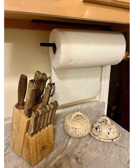 Black metal Hyde Hall Paper Towel Holder by Industrial Farm Co mounted under kitchen cabinet above marble countertop with ...