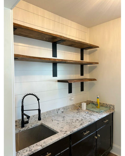 Industrial Farm Co black steel L-bracket shelf supports holding rustic wood shelves in modern farmhouse kitchen with white...