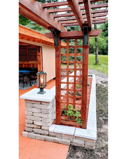 Rustic wooden pergola with cedar trellis panels and stone pillar featuring lantern, showcasing outdoor architectural desig...