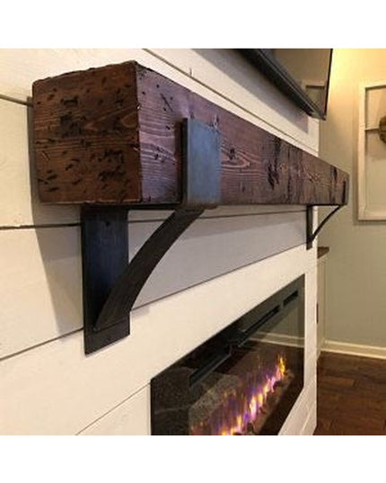 Kudlick Farmhouse wooden mantel bracket in rustic brown finish supporting reclaimed wood beam above white electric firepla...
