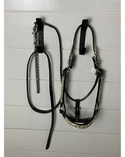 Black leather horse bridle and reins with silver decorative accents hanging on white wall - The Henrietta 1" Wide Double H...