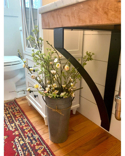 Black metal Rochester countertop bracket supporting wood kitchen island with rustic farmhouse styling by Industrial Farm Co