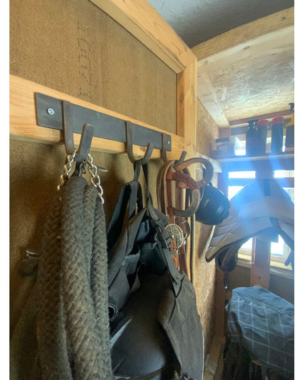 Camillus Style Coat Rack by Industrial Farm Co with wooden frame and metal hooks holding coats and bags in rustic interior