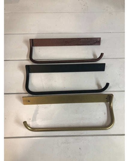 Three Hyde Hall Paper Towel Holders by Industrial Farm Co in bronze, black, and brass finishes mounted on white shiplap wall
