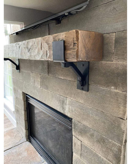 Heavy duty black steel Buffalo 4-inch mantel bracket with square support bar supporting rustic wood beam mantel above ston...