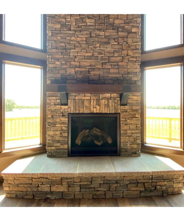 Rustic wooden Otisco Farmhouse Style Bracket supporting stone fireplace mantel with stacked stone surround and large windows