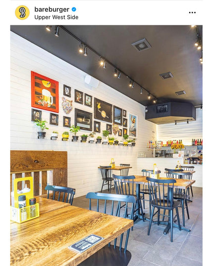 Restaurant interior featuring Industrial Farm Co Hudson Wall Planter Rings mounted on white shiplap wall with green plants...