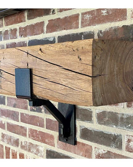 Heavy duty steel Buffalo 4 inch mantel bracket with square support bar supporting reclaimed wood beam on brick wall, handm...