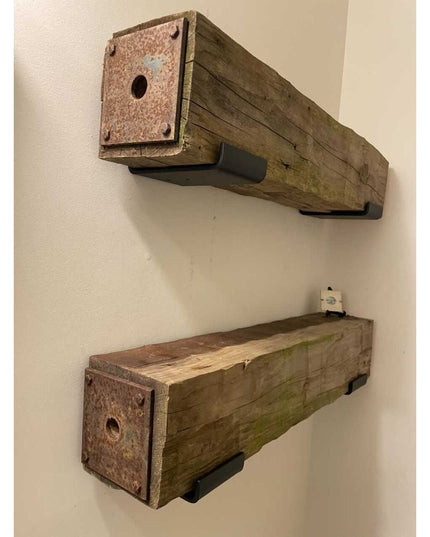 Rustic weathered wood floating shelves with metal end caps and black mounting brackets by Industrial Farm Co, showing natu...