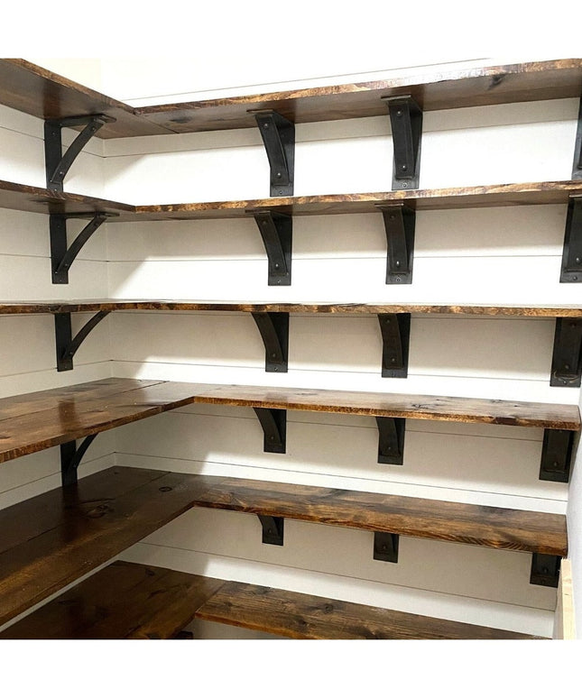 Black metal Cortland shelf brackets with rivets supporting rustic wood shelves in white shiplap pantry corner shelving sys...