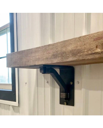 Black metal Rosamond shelf bracket supporting reclaimed wood shelf against white shiplap wall by Industrial Farm Co
