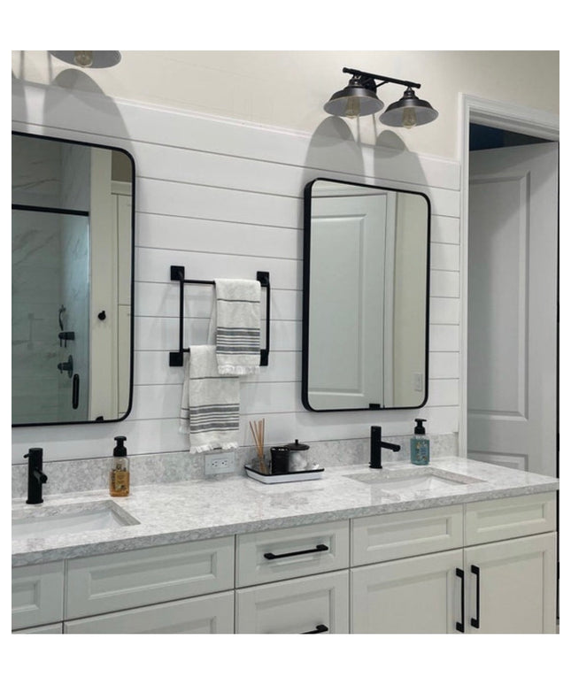 Black metal Parker Hand Towel Holder ladder mounted on white shiplap bathroom wall between two mirrors with folded towels ...