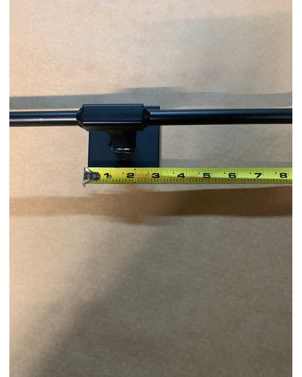 Black metal Fortworth Towel Bar by Industrial Farm Co mounted on white wall with measuring tape showing scale