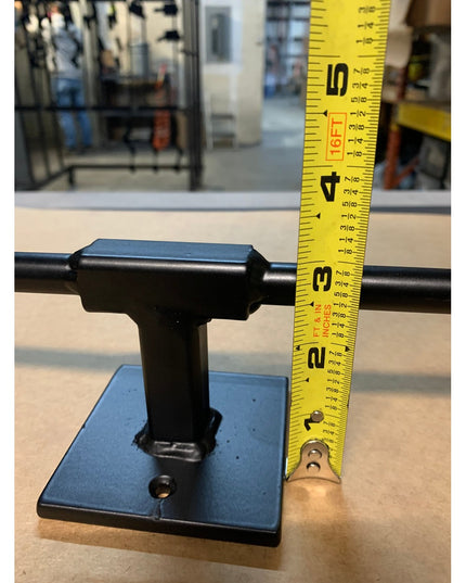 Black metal Fortworth Towel Bar by Industrial Farm Co mounted on blue base with measuring tape showing industrial farmhous...