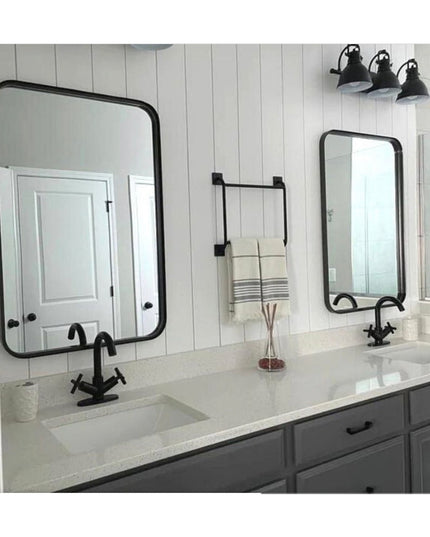 Black metal Parker Hand Towel Holder ladder-style rack mounted on white shiplap wall between two bathroom mirrors with fol...