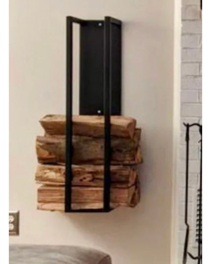 Black metal wall-mounted Toby Firewood Holder by Industrial Farm Co displaying stacked split logs in modern home interior