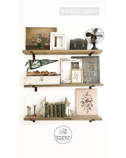 Rustic wood floating shelves with black metal KT Z Style Shelf Supports displaying vintage decor, books, and floral artwor...