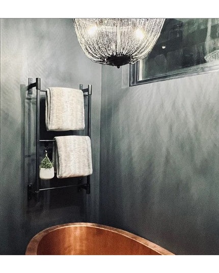 Industrial Farm Co Wall Mounted Ossit Ladder in black metal with white towels and small plant in modern bathroom