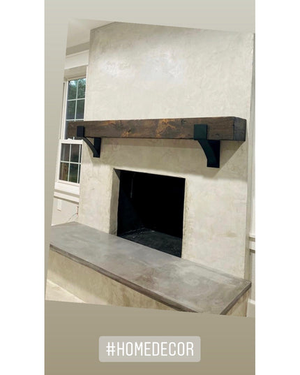 Kudlick Farmhouse black metal mantel brackets supporting rustic wooden beam above modern concrete fireplace by Industrial ...