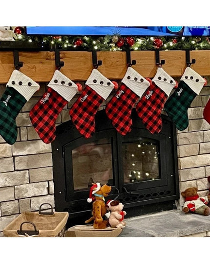 Industrial Farm Co Annie black metal stocking holder displaying six plaid Christmas stockings hung on fireplace mantel wit...