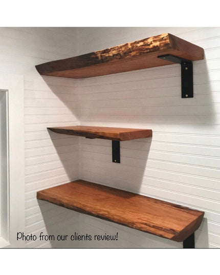 Three rustic wood floating shelves with black metal L-brackets mounted on white shiplap wall, showcasing The Lucas L Brack...