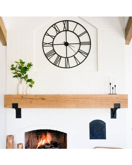 Black metal mantel brackets supporting rustic wood beam above white brick fireplace, Industrial Farm Co Buffalo 4 inch squ...