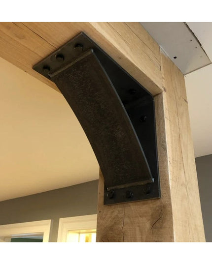 Heavy duty curved steel shelf bracket in dark finish mounted on wooden beam showing industrial design and robust construct...