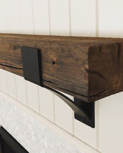 Kudlick Farmhouse Mantel Bracket in dark wood finish supporting rustic wooden beam on white fireplace mantel by Industrial...