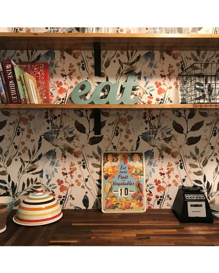 Kitchen shelf with floral wallpaper displaying Lafayette L Shelf Bracket supporting books, decorative items, and vintage s...