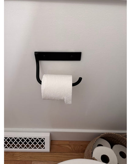 Black metal wall-mounted Howlett Hill Toilet Paper Holder by Industrial Farm Co with white toilet paper roll installed on ...