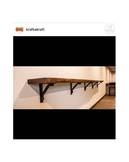 Industrial rustic wood shelf mounted on white wall with black metal Butch Shelf Support brackets by Industrial Farm Co