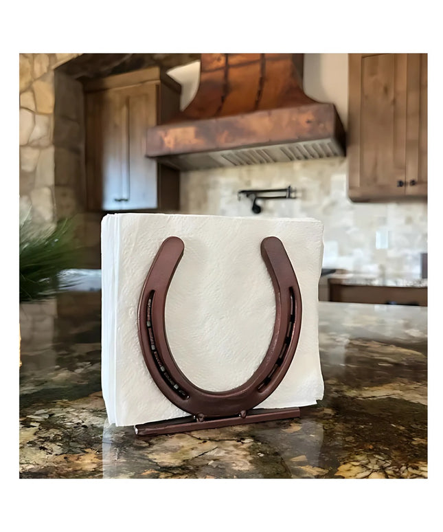 Industrial Farm Co rustic brown horseshoe napkin holder displaying white napkins on granite countertop in farmhouse kitchen