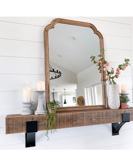 Kudlick Farmhouse wooden mantel shelf with black metal brackets mounted on white shiplap wall, decorated with mirror, cand...