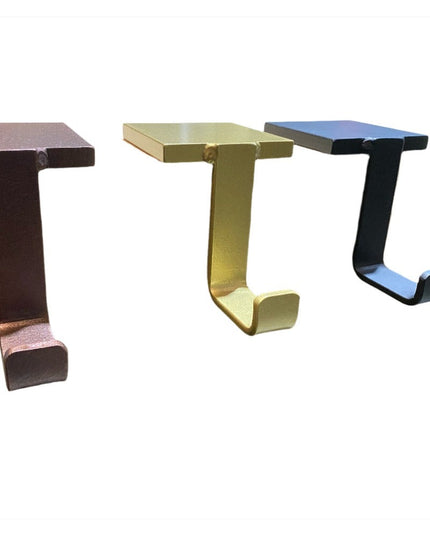 Three Annie Stocking Holders by Industrial Farm Co in copper, brass, and black finishes, showing C-shaped metal hooks for ...