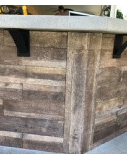 Heavy duty black steel Albany 4" industrial shelf brackets supporting granite countertop on rustic wood kitchen island by ...