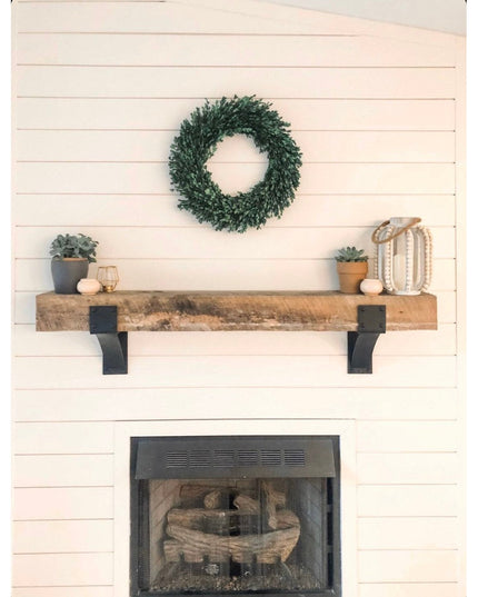 Clermont 4-inch black steel mantel brackets with rivets supporting rustic wood beam shelf above white shiplap fireplace by...