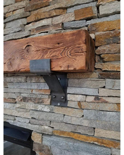 Fulton Style Heavy Duty Mantel Support black metal bracket holding reclaimed wood beam on stacked stone wall by Industrial...