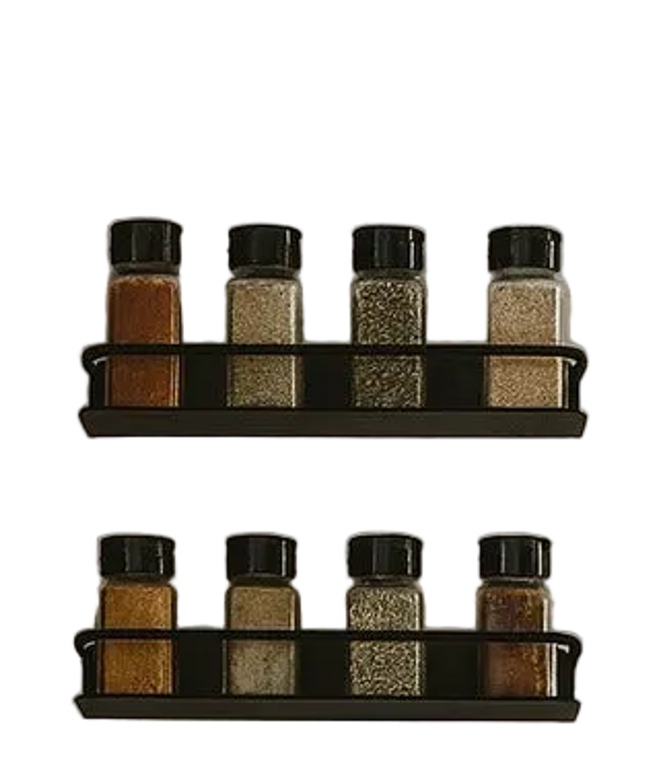 Herdon matte black metal wall mounted spice racks holding glass jars with spices in rustic farmhouse kitchen with wood cab...