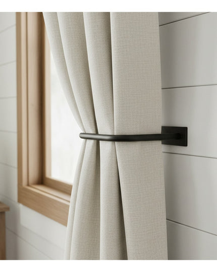 Black metal horse head curtain tie back holding beige linen curtains against white shiplap wall by Industrial Farm Co