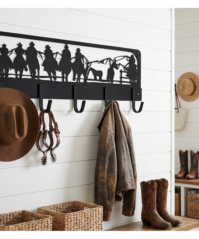 Western Charm black metal wall-mounted coat rack with cowboy silhouette cutout displaying cowboy hat, jacket, and spurs in...