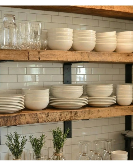 Heavy duty black steel L-shaped shelf brackets supporting rustic wood shelves with white dishes and glassware in modern fa...