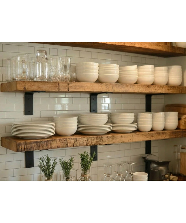 Heavy duty black steel L-shaped shelf brackets supporting rustic wood shelves with white dishes and glassware in modern fa...