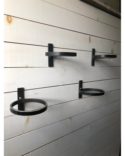 Black metal Smoral Handmade Pot Holders by Industrial Farm Co mounted on white shiplap wall, featuring circular rings and ...