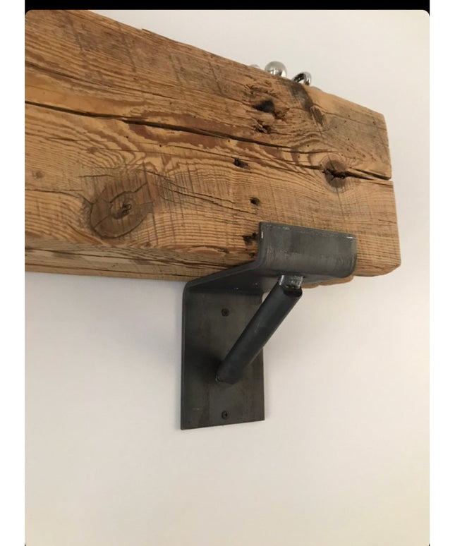 Rustic reclaimed wood beam with black metal Industrial Farm Co Shaver Open Shelving Support bracket mounted on white wall