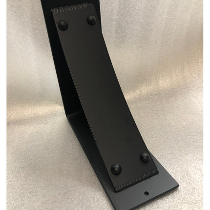 Black metal Utica Support bracket by Industrial Farm Co with curved L-shape design and riveted details on neutral background