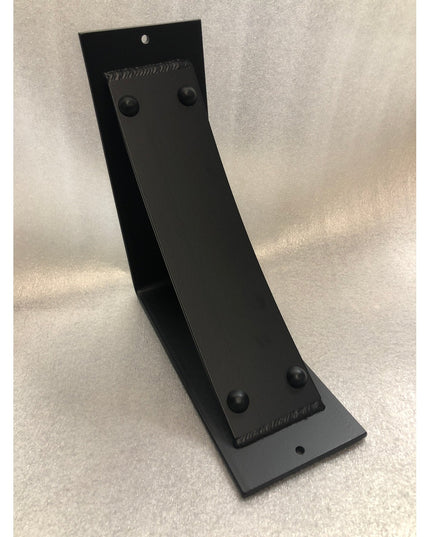 Black metal Utica Support bracket by Industrial Farm Co with curved L-shape design and riveted details on neutral background